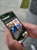 Image of man holding phone, with the ASK A MATE app open on the phone